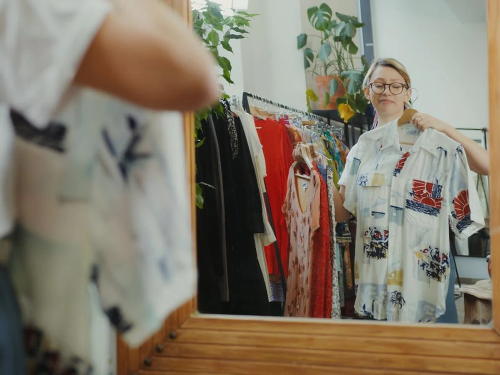 A woman preparing a stylish everyday outfit in bright natural light