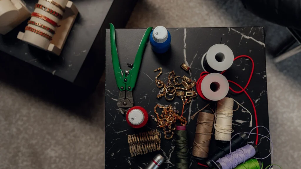 Top view of a crafting table with tools, spools, and jewelry making materials. — selected for United Kingdom readers