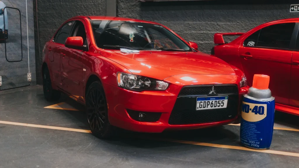 Bright red car parked indoors near a WD-40 can, showcasing a shiny modern vehicle in a garage. — selected for United Kingdom readers
