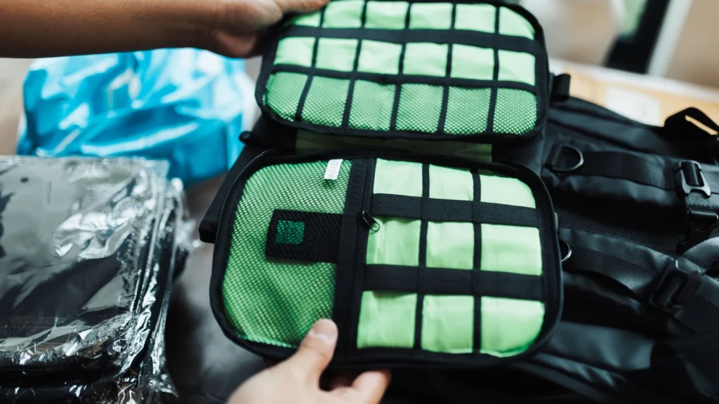 Close-up of hands organizing a travel luggage with packing cubes for efficient packing. — selected for United States readers