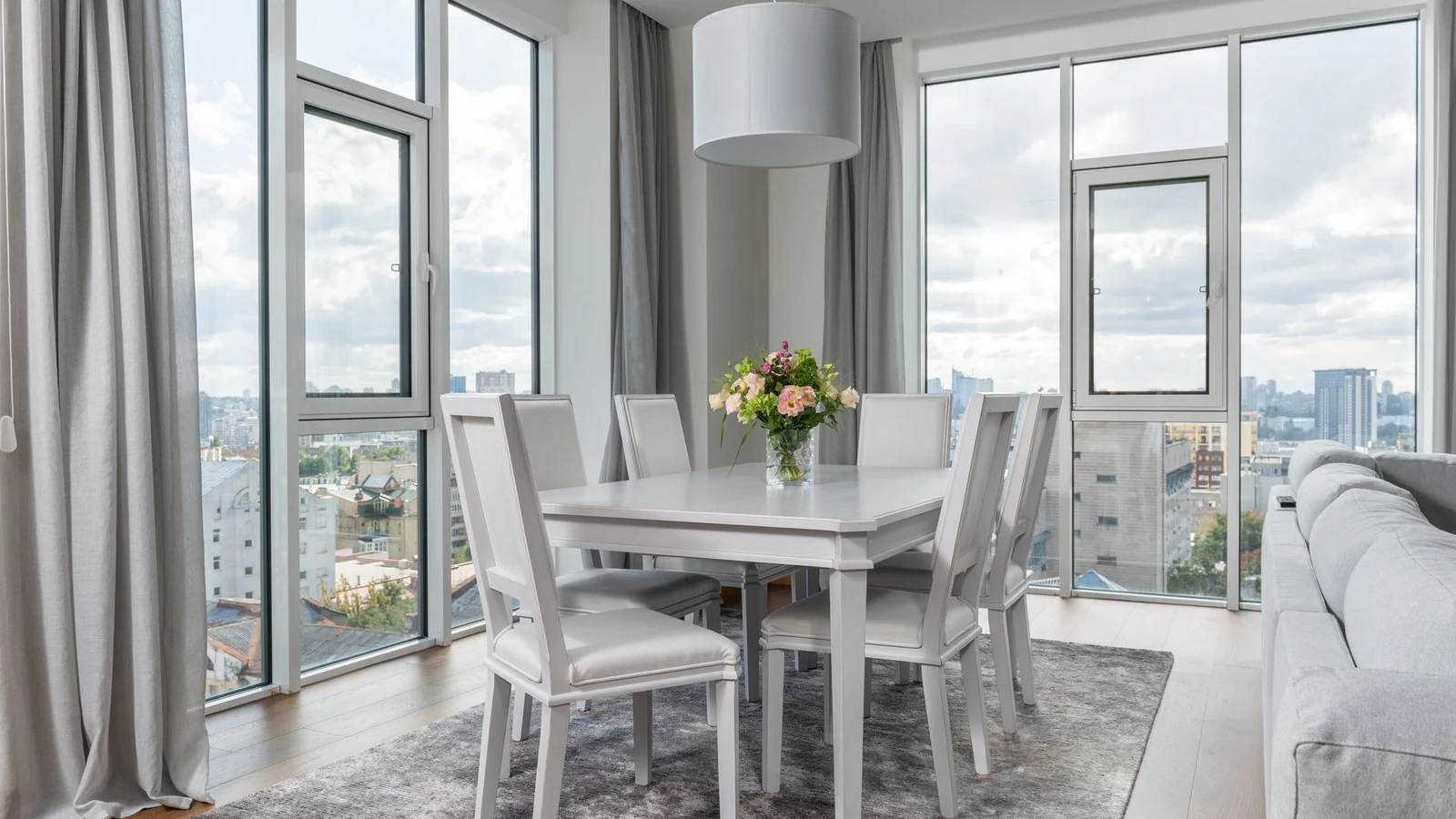 Interior of spacious contemporary dining room with stylish light furniture and panoramic windows in daylight — selected for United Kingdom readers