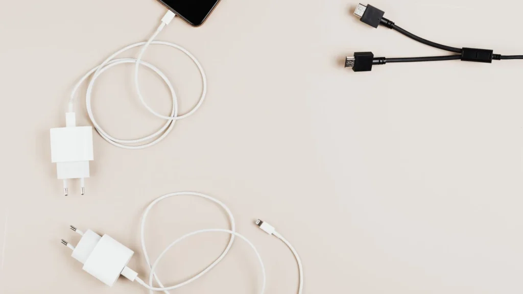 Flat lay of mobile devices with chargers and cables on a neutral background. — selected for United States readers