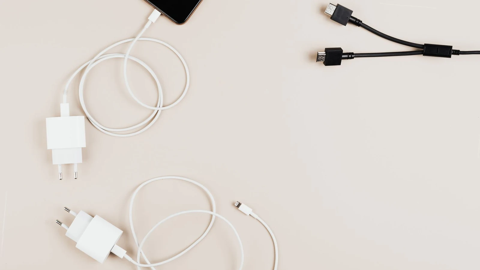 Flat lay of mobile devices with chargers and cables on a neutral background. — selected for United States readers