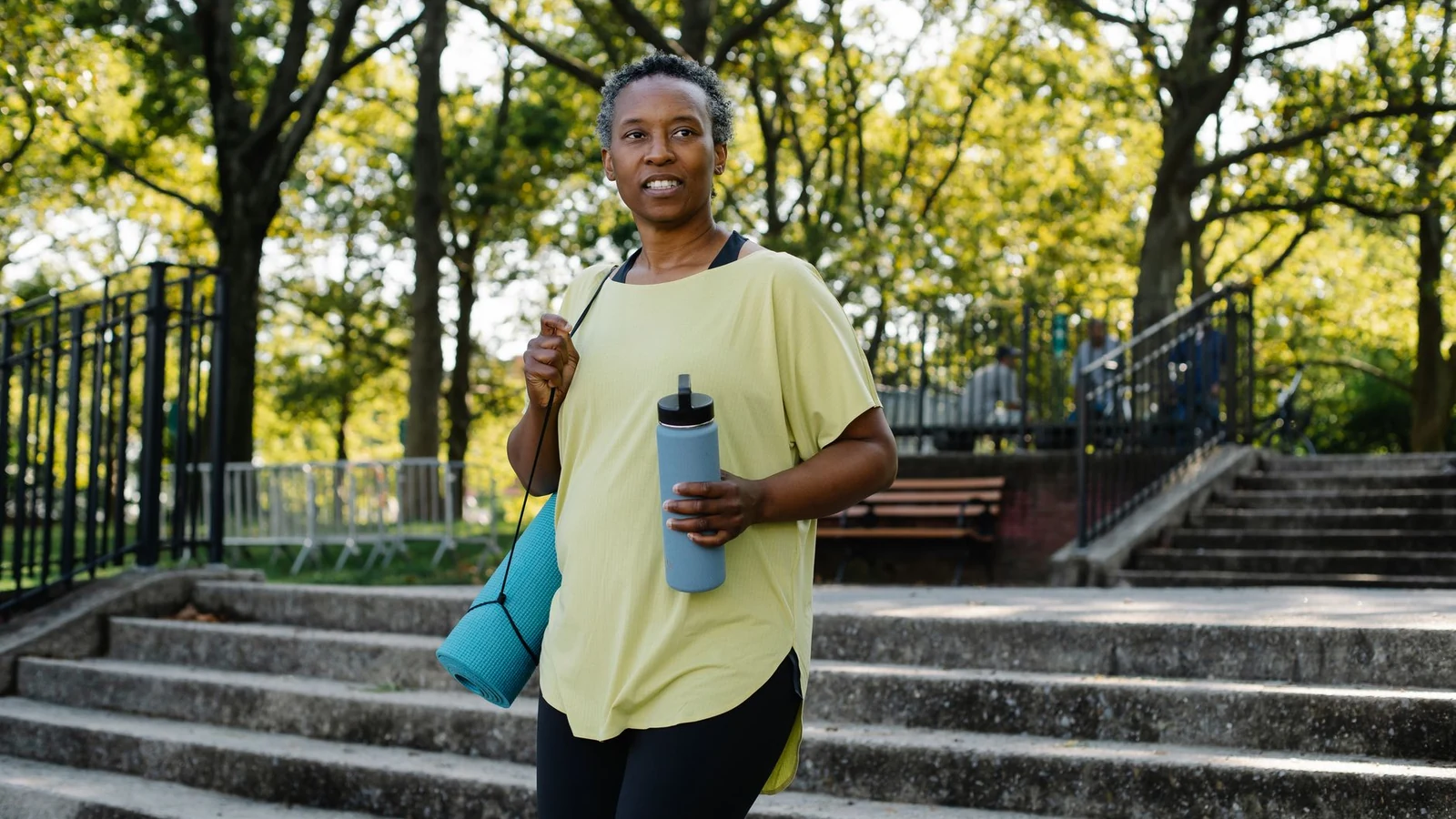 Active woman takes a break during her outdoor workout in a sunny park. — selected for United Kingdom readers