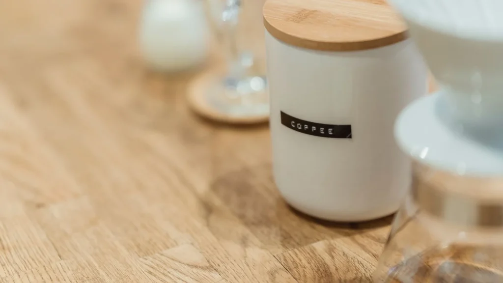 Close-up of a ceramic coffee jar with a wooden lid on a table, perfect for stylish kitchen storage. — selected for United States readers