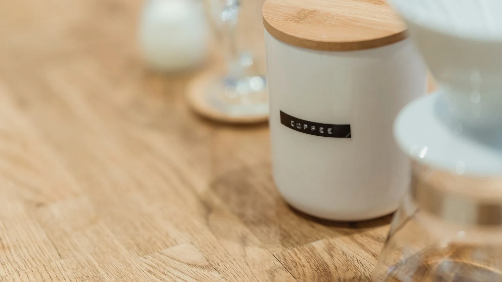 Close-up of a ceramic coffee jar with a wooden lid on a table, perfect for stylish kitchen storage. — selected for United States readers