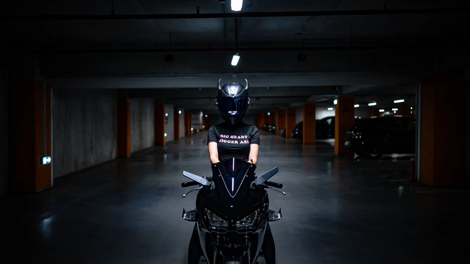 Motorcyclist wearing helmet on a motorcycle in a dimly lit parking garage, creating a cinematic feel. — selected for United States readers