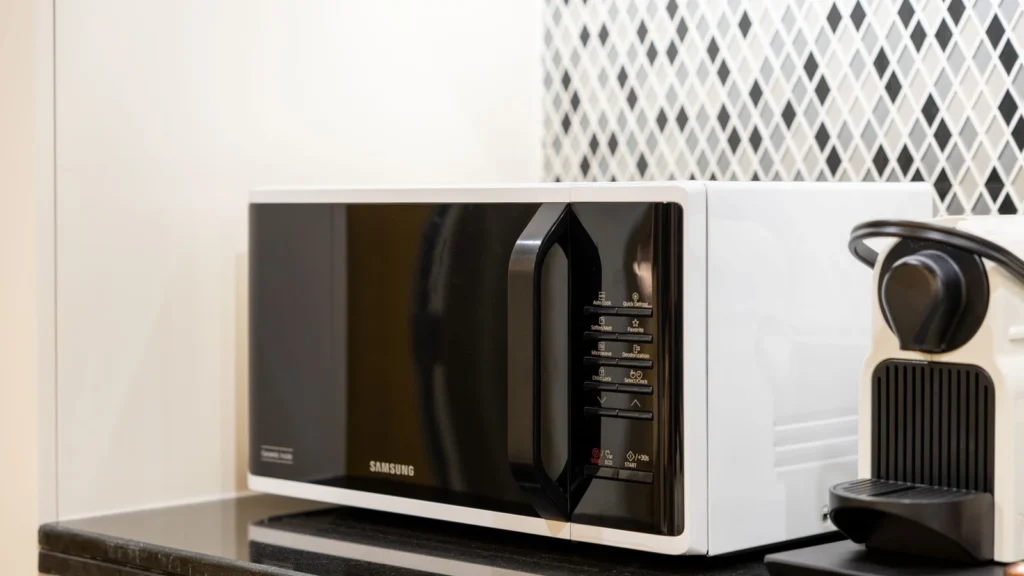 Stylish kitchen setup featuring a black microwave and coffee maker on a counter. — selected for United States readers