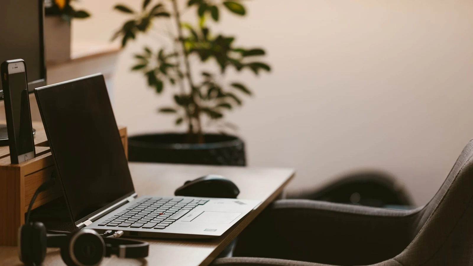 A cozy home office workspace with a laptop, headphones, and a plant. Ideal for remote work. — selected for United States readers