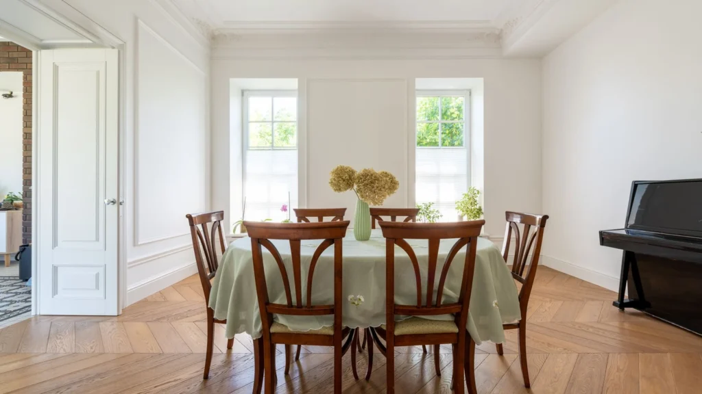 Bright dining room featuring wooden chairs, a table, and a piano, offering a classic home interior. — selected for United Kingdom readers